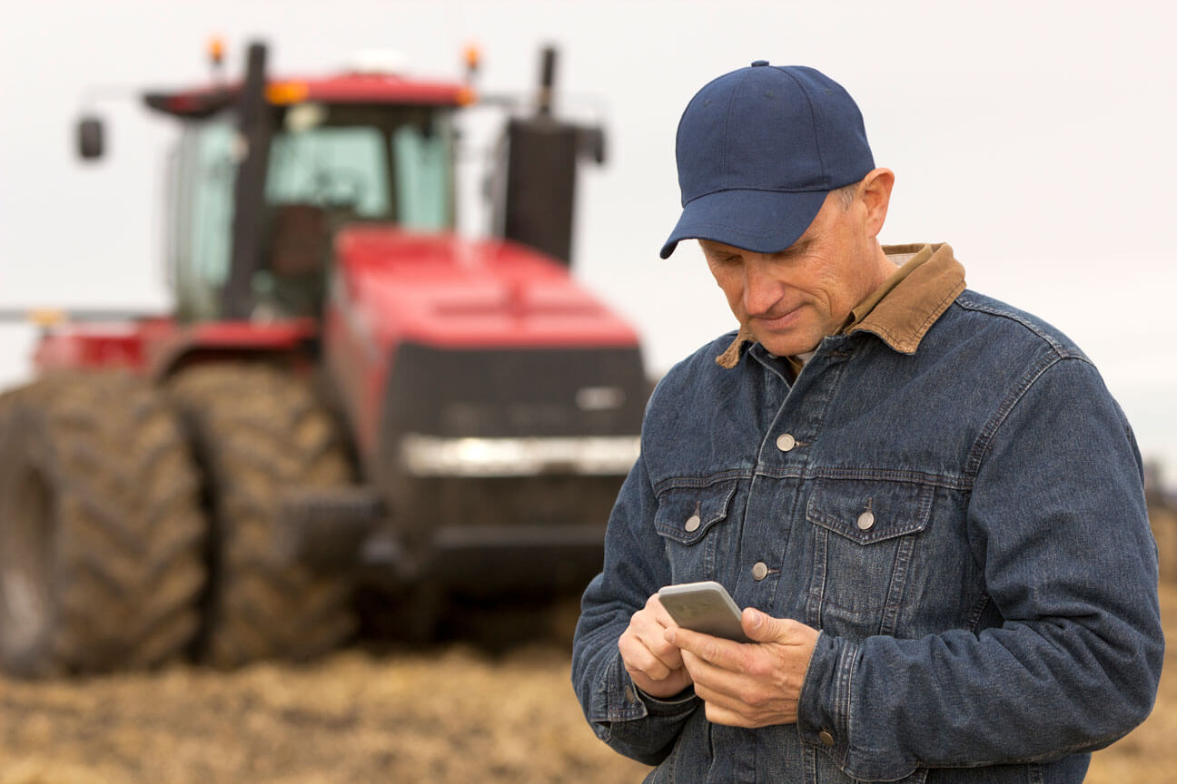 Man on Phone - Tractor in Background